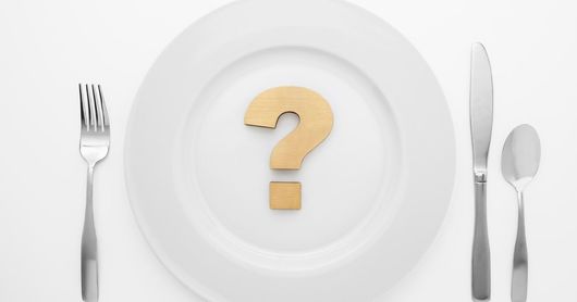 Feed brass question mark on white plate